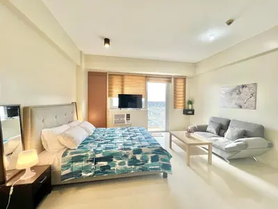 a living room with a bed and a couch at Kiel 4-Star Condo Hotel Near NAIA Manila Airport Terminal in Manila