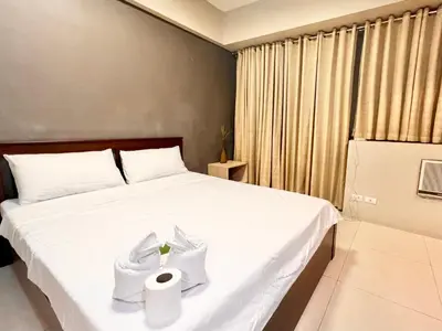 a bedroom with a bed with towels on it at Kiel 4-Star Condo Hotel Near NAIA Manila Airport Terminal in Manila