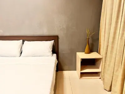 a bedroom with a bed and a side table at Kiel 4-Star Condo Hotel Near NAIA Manila Airport Terminal in Manila