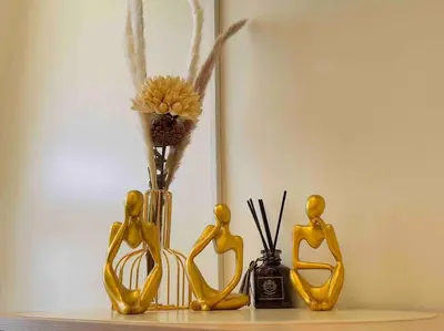 a group of yellow figurines next to a vase with flowers at Kasara De Ulap BEST Staycation - 25th Floor City View - Pool & Fast Wi-Fi in Manila