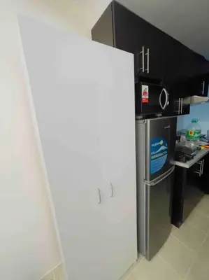 a white refrigerator in a kitchen with a counter at Kasara De Ulap BEST Staycation - 25th Floor City View - Pool & Fast Wi-Fi in Manila