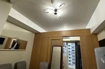 a room with a ceiling with a door and a light at Tropical Balcony Pool View, 14th floor, MOA, Netflix, Airport at Shell Residence in Manila