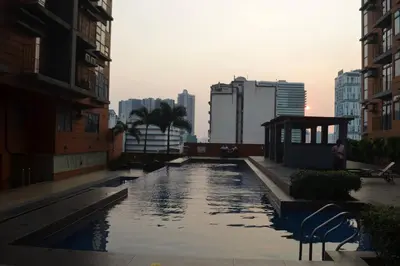 a pool of water in a city with buildings at Cozy Studio with Beautiful View & FREE Netflix Access in Manila