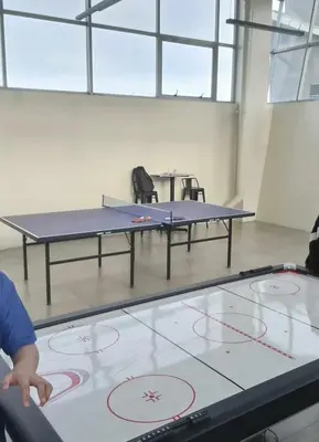 a person playing ping pong on a ping pong table at Cozy Studio with Beautiful View & FREE Netflix Access in Manila