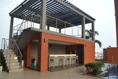 a building with a balcony with a table and chairs at Cozy Studio with Beautiful View & FREE Netflix Access in Manila