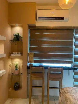 a room with a window with a desk and two chairs at Breeze Residences with Ocean view by Bmars in Manila