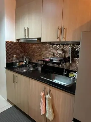 a kitchen with a sink and a counter top at Breeze Residences with Ocean view by Bmars in Manila