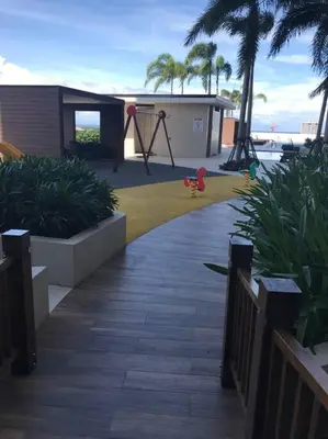 a playground with a swing and a play implement at Breeze Residences with Ocean view by Bmars in Manila
