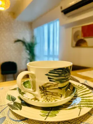 a coffee cup and saucers on a table at 2Bedroom Loft Type Unit in BGC by K Suites in Manila