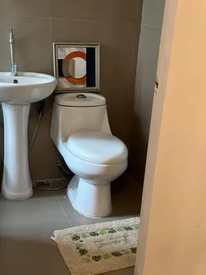 a bathroom with a white toilet and a sink at 2Bedroom Loft Type Unit in BGC by K Suites in Manila