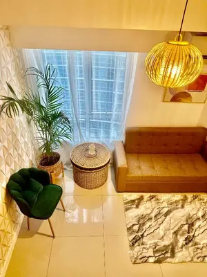 a living room with a couch and a window at 2Bedroom Loft Type Unit in BGC by K Suites in Manila