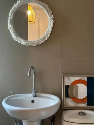 a bathroom with a sink and a mirror at 2Bedroom Loft Type Unit in BGC by K Suites in Manila