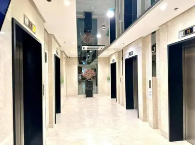 a hallway in a building with black doors at Cozy 1BR at Shore 2 with balcony in Manila
