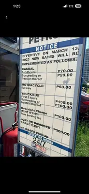 a sign in front of a house with a price sign at Cozy 1BR at Shore 2 with balcony in Manila