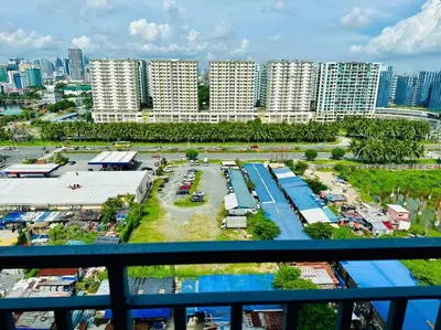 an aerial view of a parking lot in a city at Cozy 1BR at Shore 2 with balcony in Manila