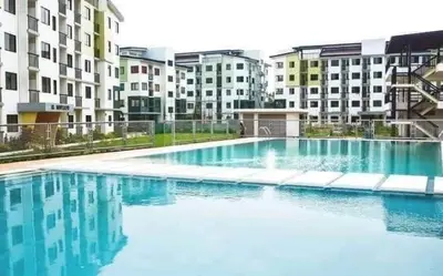 a large pool of blue water in front of buildings at Casa Cabilao Staycation in Santa Rosa