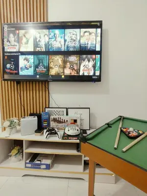 a room with a pool table and a flat screen tv at Azure resort Paranaque deluxe 8 plus 2toddler free in Manila