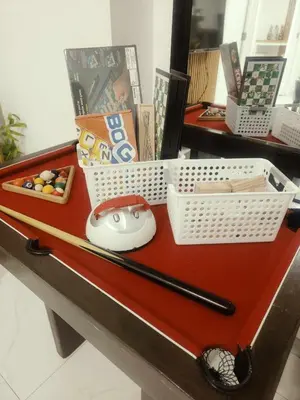 a table with a baseball bat and a basket on it at Azure resort Paranaque deluxe 8 plus 2toddler free in Manila