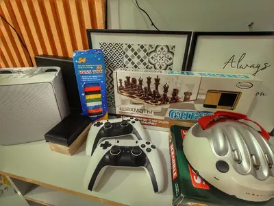 a table with a video game controller and other items on it at Azure resort Paranaque deluxe 8 plus 2toddler free in Manila