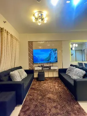 a living room with two couches and a flat screen tv at Two Bedroom Fully Furnished 70sqm CONDO MIREA RESIDENCES PASIG in Manila