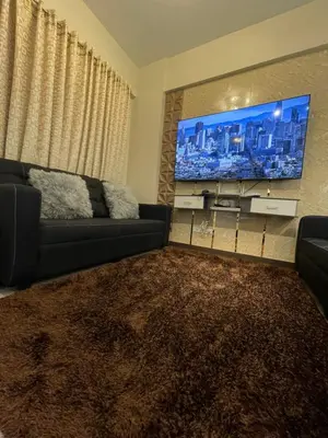 a living room with a couch and a flat screen tv at Two Bedroom Fully Furnished 70sqm CONDO MIREA RESIDENCES PASIG in Manila