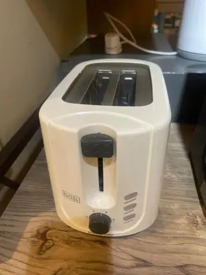 a white toaster sitting on top of a wooden table at Two Bedroom Fully Furnished 70sqm CONDO MIREA RESIDENCES PASIG in Manila