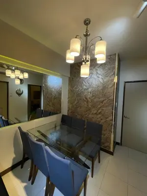 a dining room with a glass table and blue chairs at 2BHK with Balcony Fully Furnished-70sqm Condo Pasig in Manila