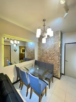 a dining room with a glass table and blue chairs at 2BHK with Balcony Fully Furnished-70sqm Condo Pasig in Manila