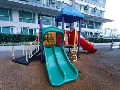 a playground with a slide and a slideintend at The Beacon Makati by Cozi Condotels in Manila