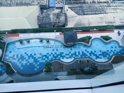 an overhead view of a swimming pool in a building at The Beacon Makati by Cozi Condotels in Manila
