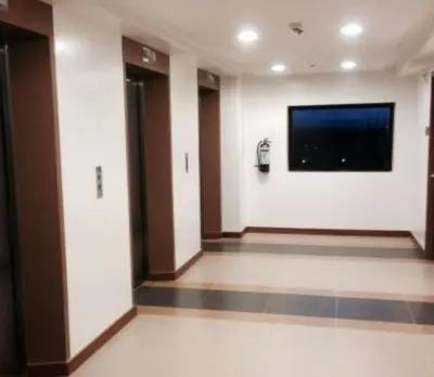 a hallway with a tv on the wall in a building at Minimalist Condo Studio City Tower 2 Filinvest Alabang Muntinlupa in Manila