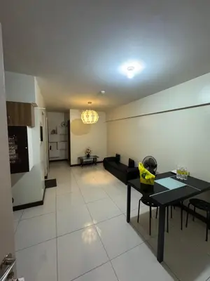 a living room with a couch and a table at Acacia Estates Taguig in Manila