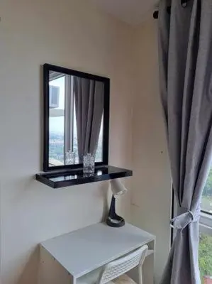 a mirror sitting on a shelf next to a window at Casa REYNA at KASARA Urban Residences in Manila