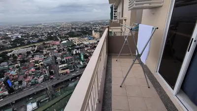 a easel on a balcony with a view of a city at Prisma residence Celeste tower PH 16B with fully furnished and fast wifi for rent in Manila