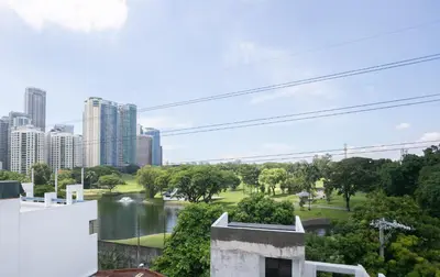 a view of the city from the balcony of a building at District Inn in Manila