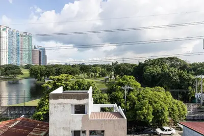 a building with a view of a river and buildings at District Inn in Manila