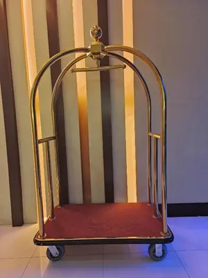 a metal luggage cart sitting in a room at Two Palmtree Villas Across Manila Airport Terminal 3 -JJRMK Condotel in Manila