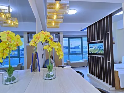 a room with two vases with yellow flowers on a table at Near Terminal 3 Two Palmtree Villas- Walking distance only (JJRMK) in Manila