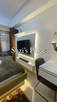 a bedroom with a bed and a tv on a wall at Suzi's Place @ Green 2 Residences Free Wi-fi & Netflix in Dasmariñas