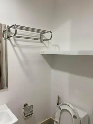 a white bathroom with a toilet and a sink at Suzi's Place @ Green 2 Residences Free Wi-fi & Netflix in Dasmariñas