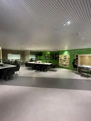 a large room with tables and chairs and green walls at Suzi's Place @ Green 2 Residences Free Wi-fi & Netflix in Dasmariñas