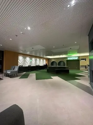 a large lobby with a large room with green carpet at Suzi's Place @ Green 2 Residences Free Wi-fi & Netflix in Dasmariñas