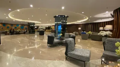 a lobby with chairs and a table in a building at Condo Suite/Apartment Pasay SM MOA - Stay Cozy & Boujee in Manila