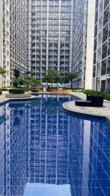 a large swimming pool in front of tall buildings at Condo Suite/Apartment Pasay SM MOA - Stay Cozy & Boujee in Manila