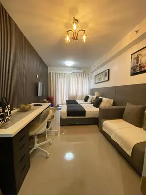 a hotel room with a bed and a desk and a bedroom at Condo Suite/Apartment Pasay SM MOA - Stay Cozy & Boujee in Manila