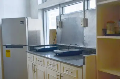a kitchen with two blue pans on a counter at JP Santiago Studio Makati J204 in Manila