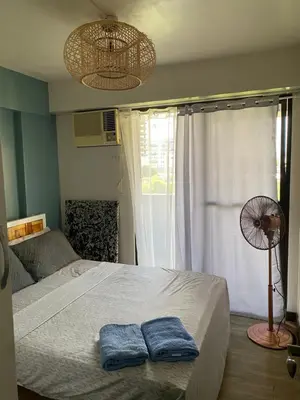 a bedroom with a bed with two towels on it at Relax@Samaya Pasig in Manila