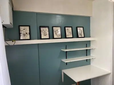 a room with shelves with pictures on the wall at Relax@Samaya Pasig in Manila