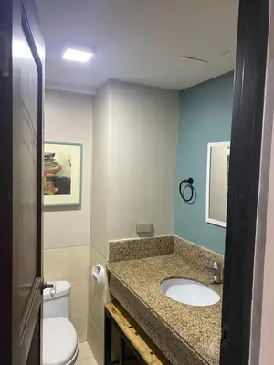 a bathroom with a sink and a toilet at Relax@Samaya Pasig in Manila