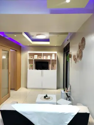 a living room with a ceiling with purple lights at Shell res nr MOA 2BR free parking in Manila